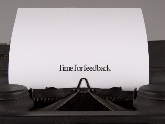 Photo of a vintage typewriter onto which the words 'Time for feedback' have been typed